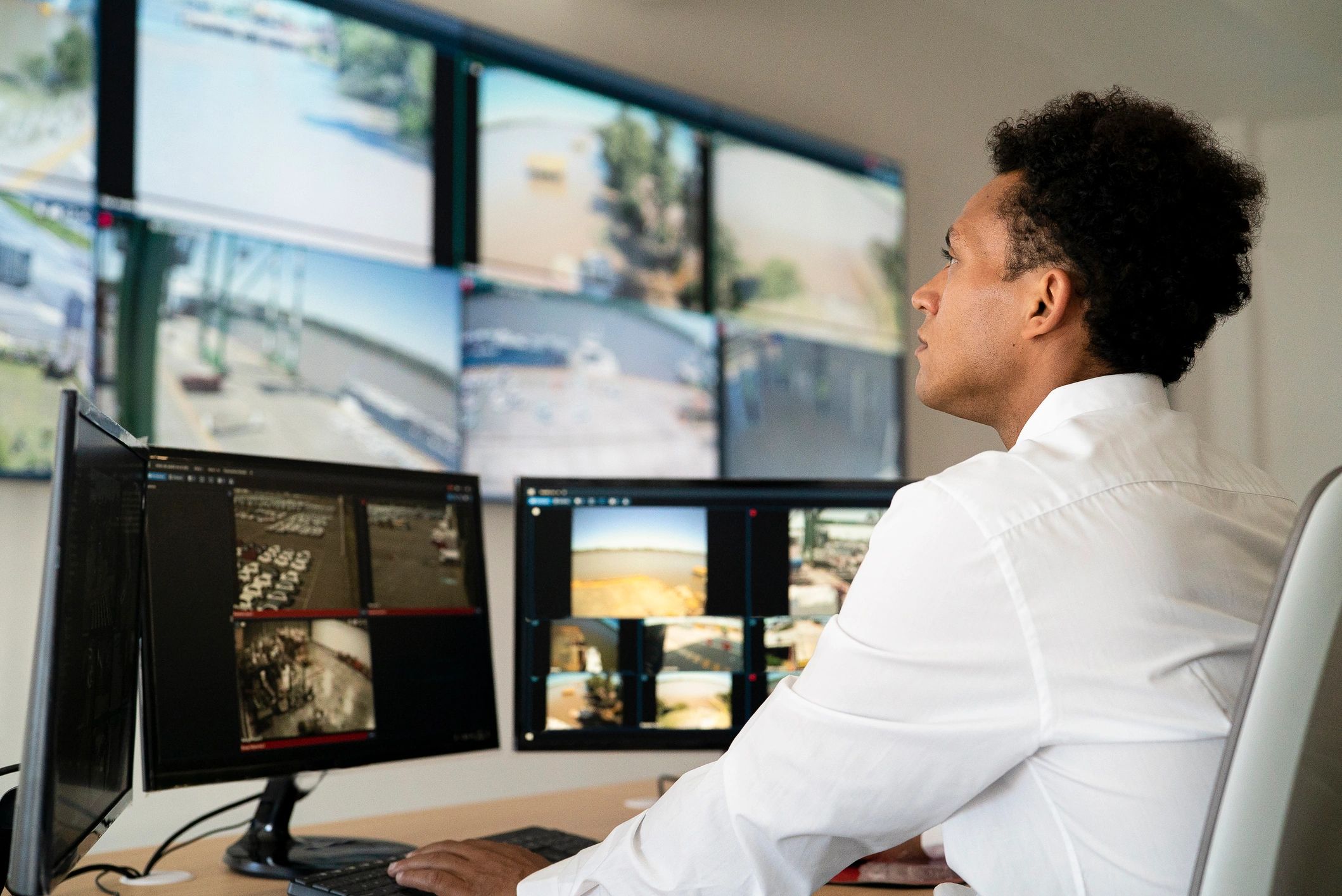 Security analyst monitoring systems at workstation