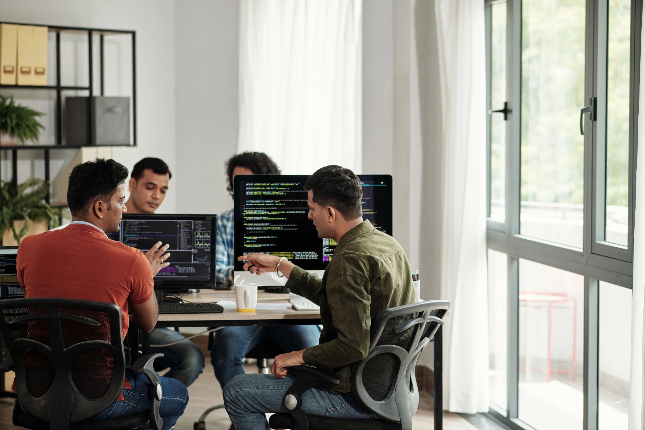Developers discussing programming code
